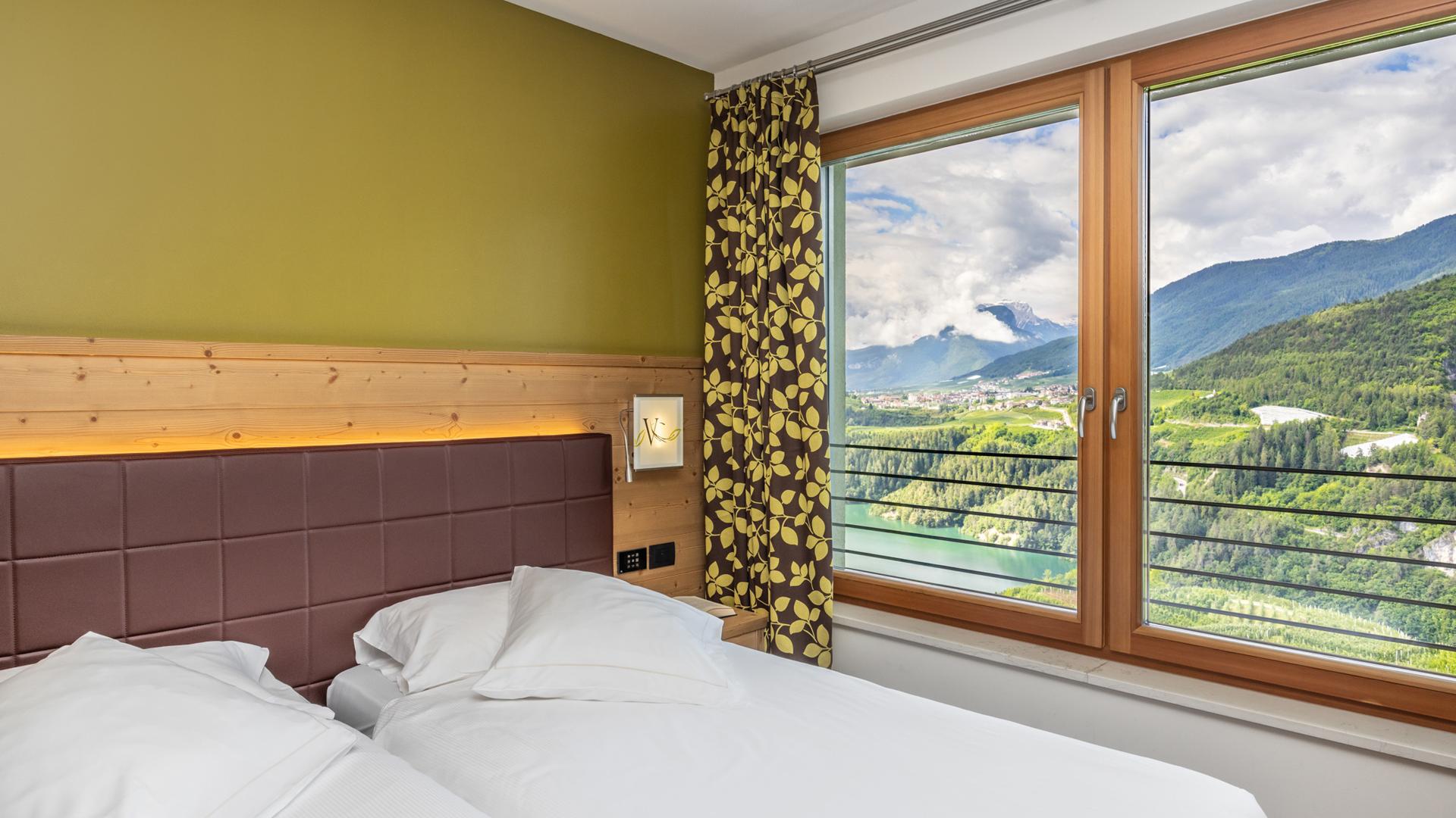 Camera con vista montagna e lago, design moderno.